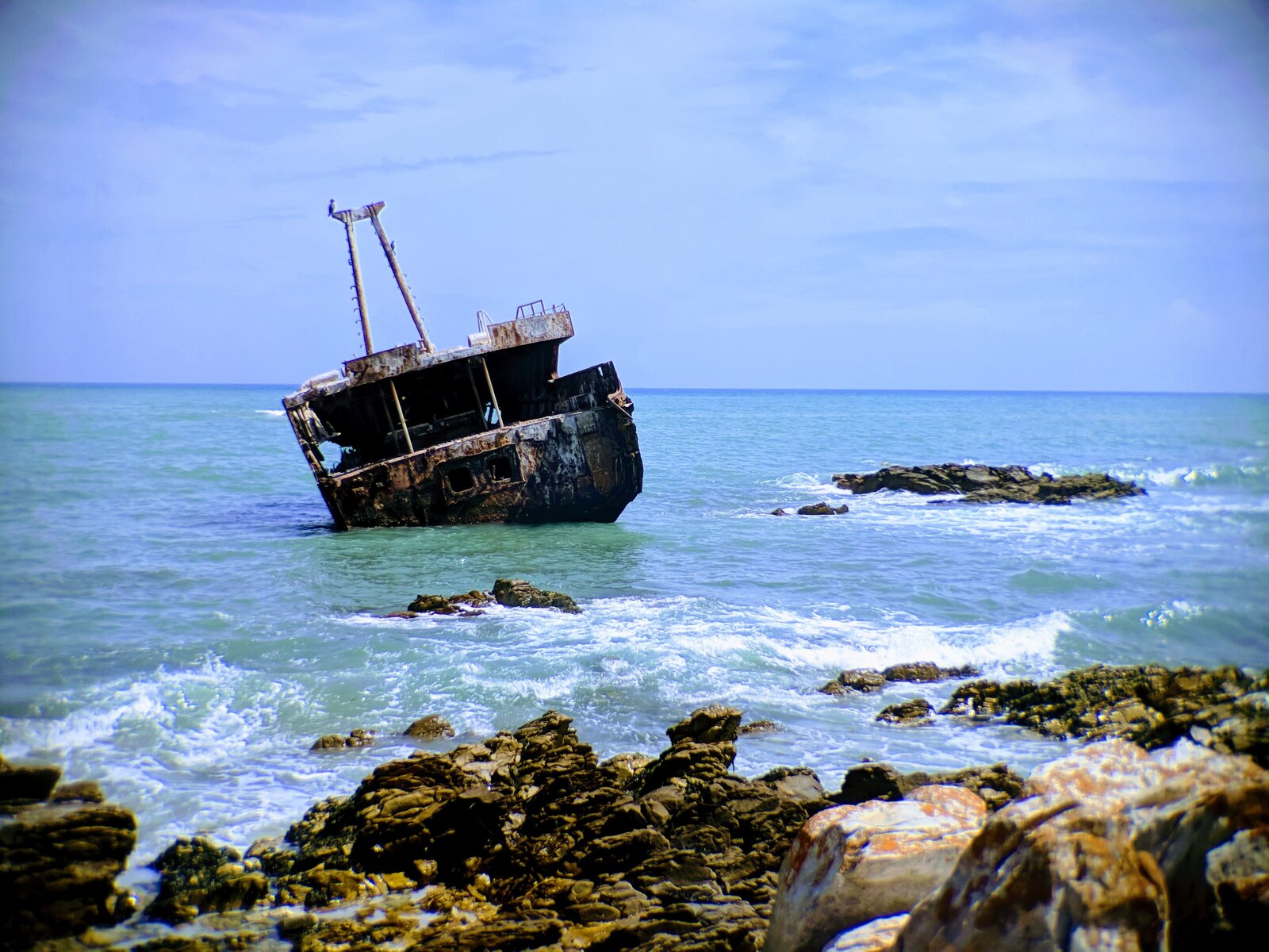 The rusted Meisho Maru wreck lying in the surf on the Agulhas coast