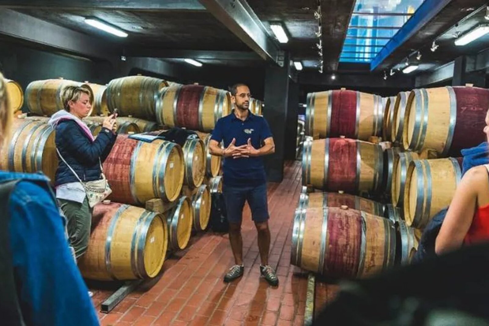 Candlelit cellar dinner among wine barrels at a Cape estate