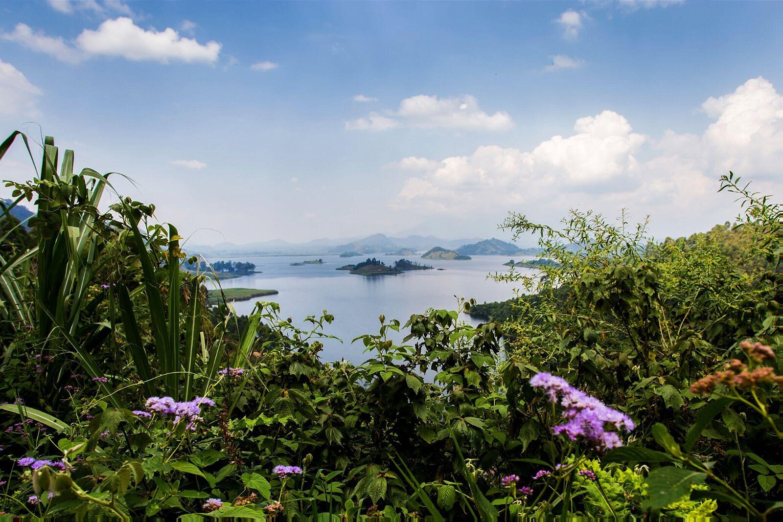 Chameleon Hill Lodge view over Lake Mutanda to the Virunga volcanoes at sunset