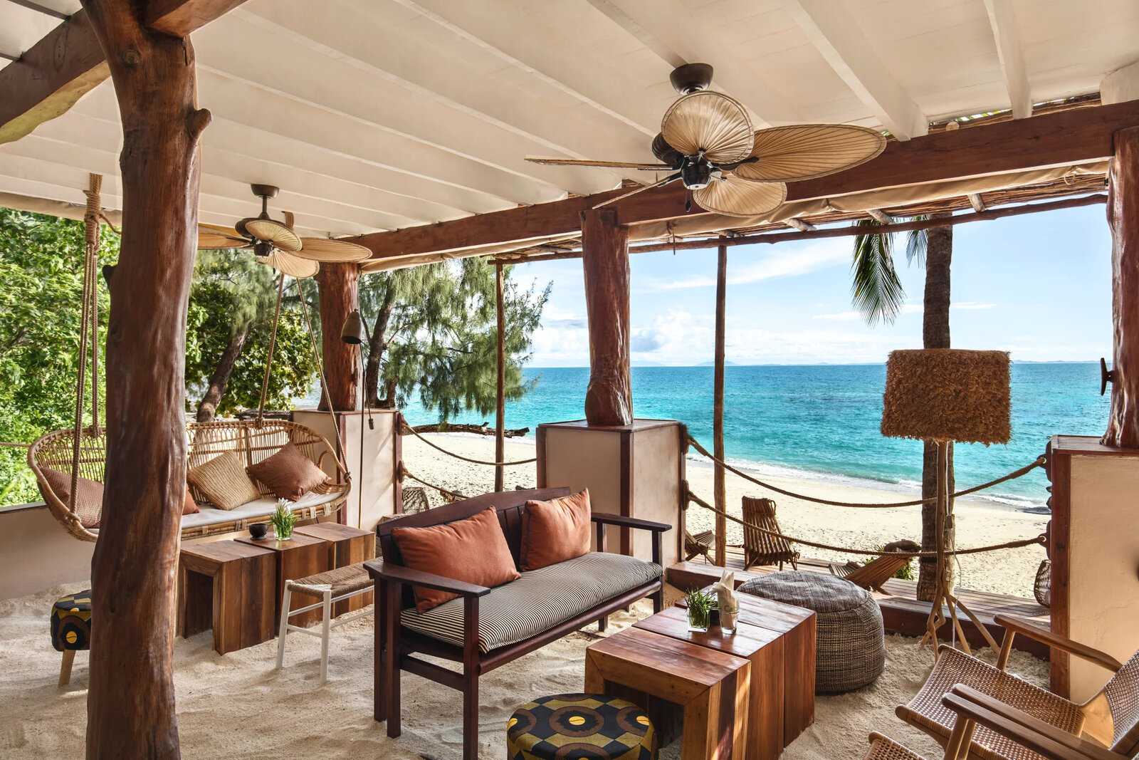 An open-air villa lounge framed by rosewood beams and forest at Constance Tsarabanjina, Madagascar
