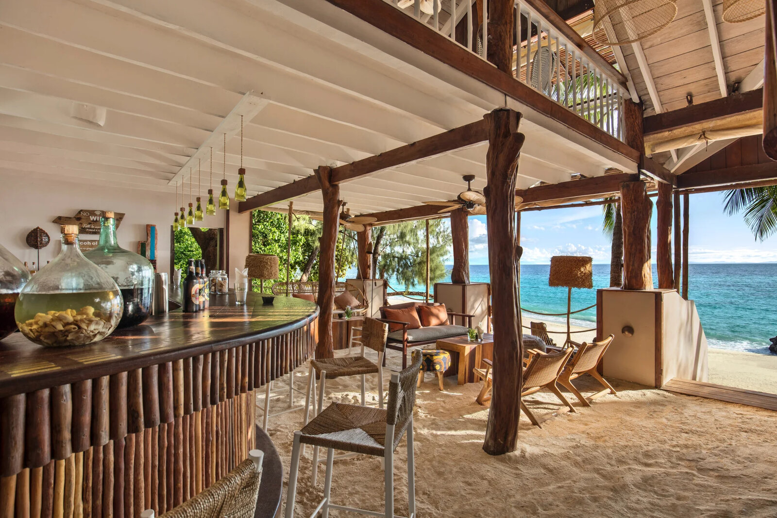 The sand-floored bar and restaurant with rosewood beams above the lagoon at Constance Tsarabanjina, Madagascar