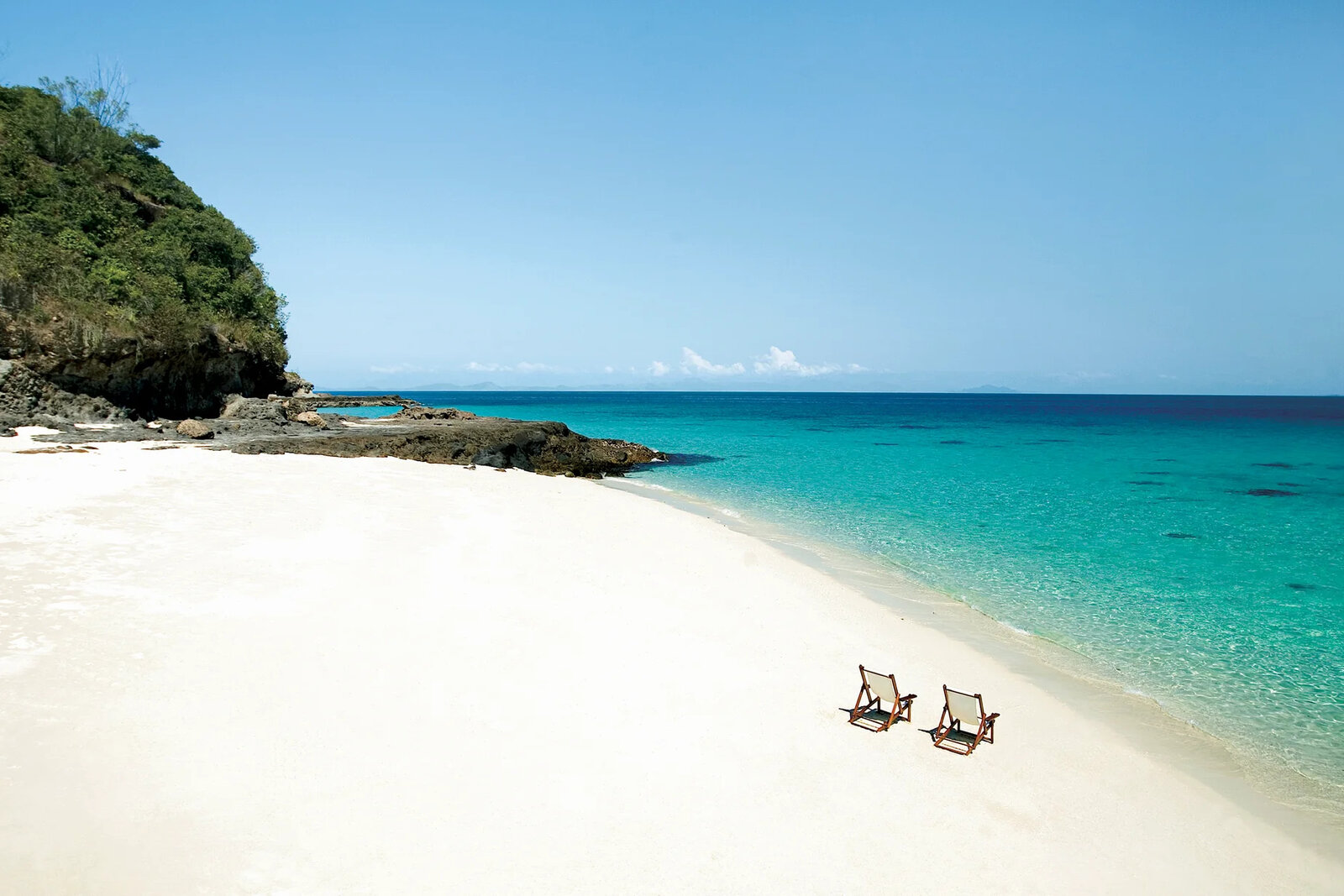 A hidden white-sand cove and turquoise water seen from the air at Constance Tsarabanjina, Mitsio Archipelago, Madagascar