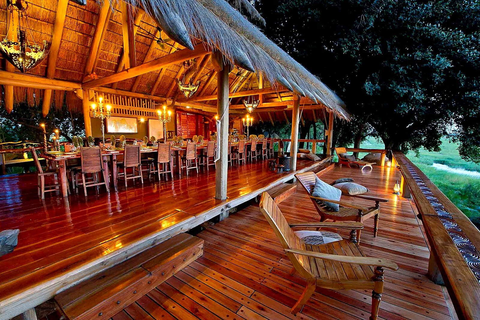 A thatched dining pavilion with long tables suited to a group buy-out