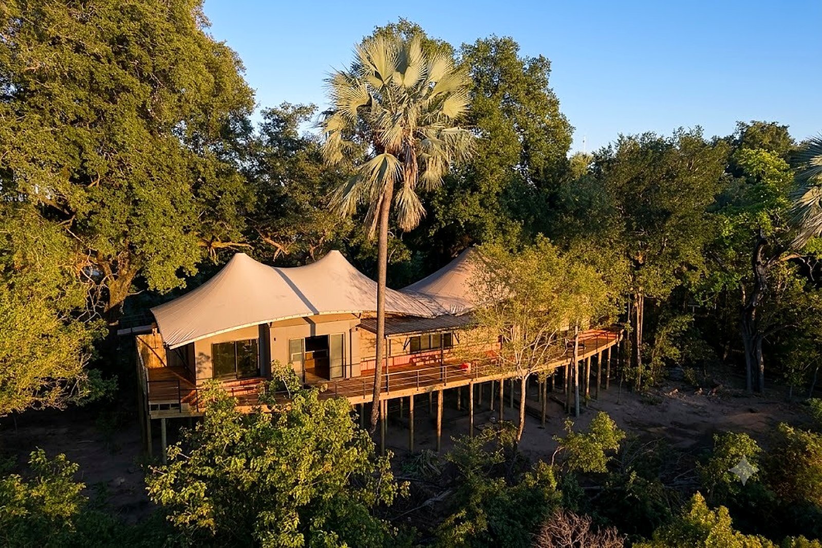 Aerial view of a raised private safari camp taken over for exclusive use