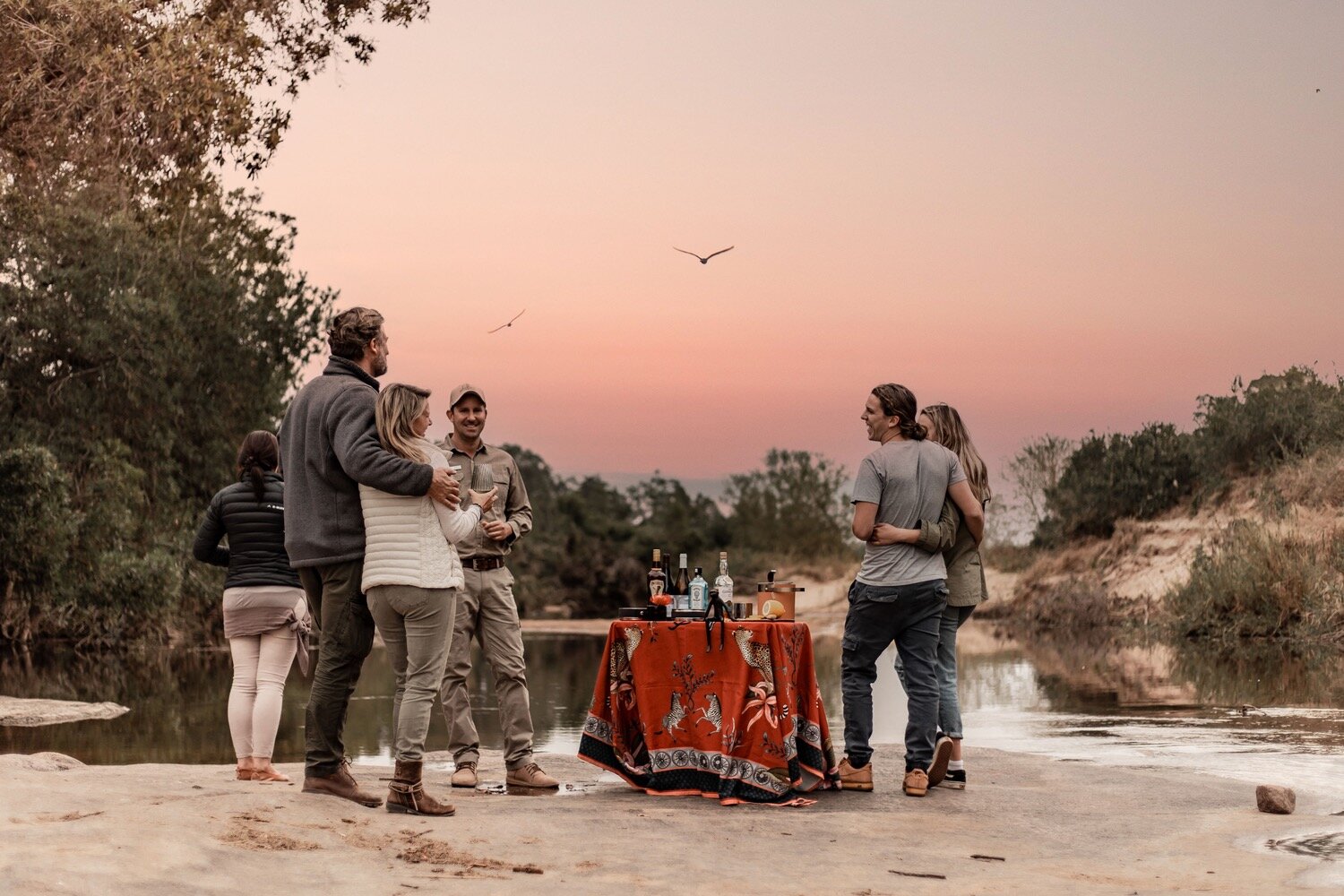 Sundowners set up on the Sand River bank at Dulini with guests and staff