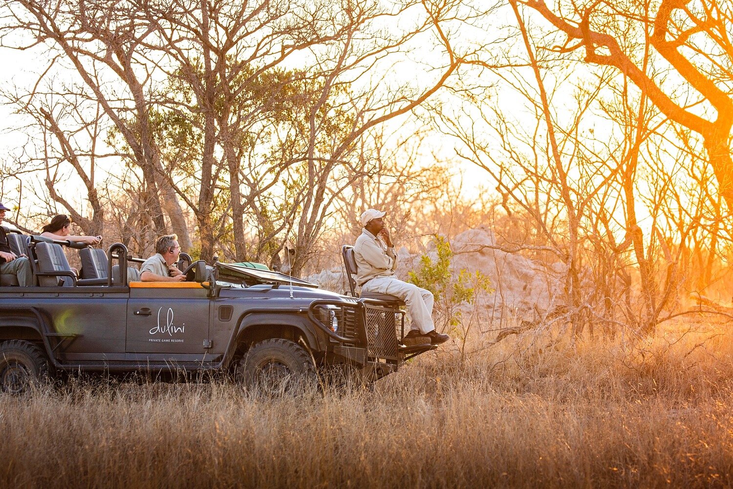 Dulini-branded game-drive vehicle in golden light in the Sabi Sand bush