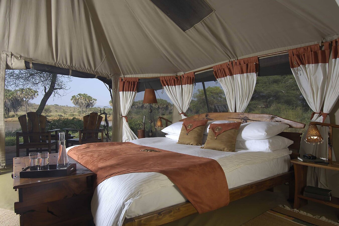 Spacious bedroom with plush bedding and river-facing windows