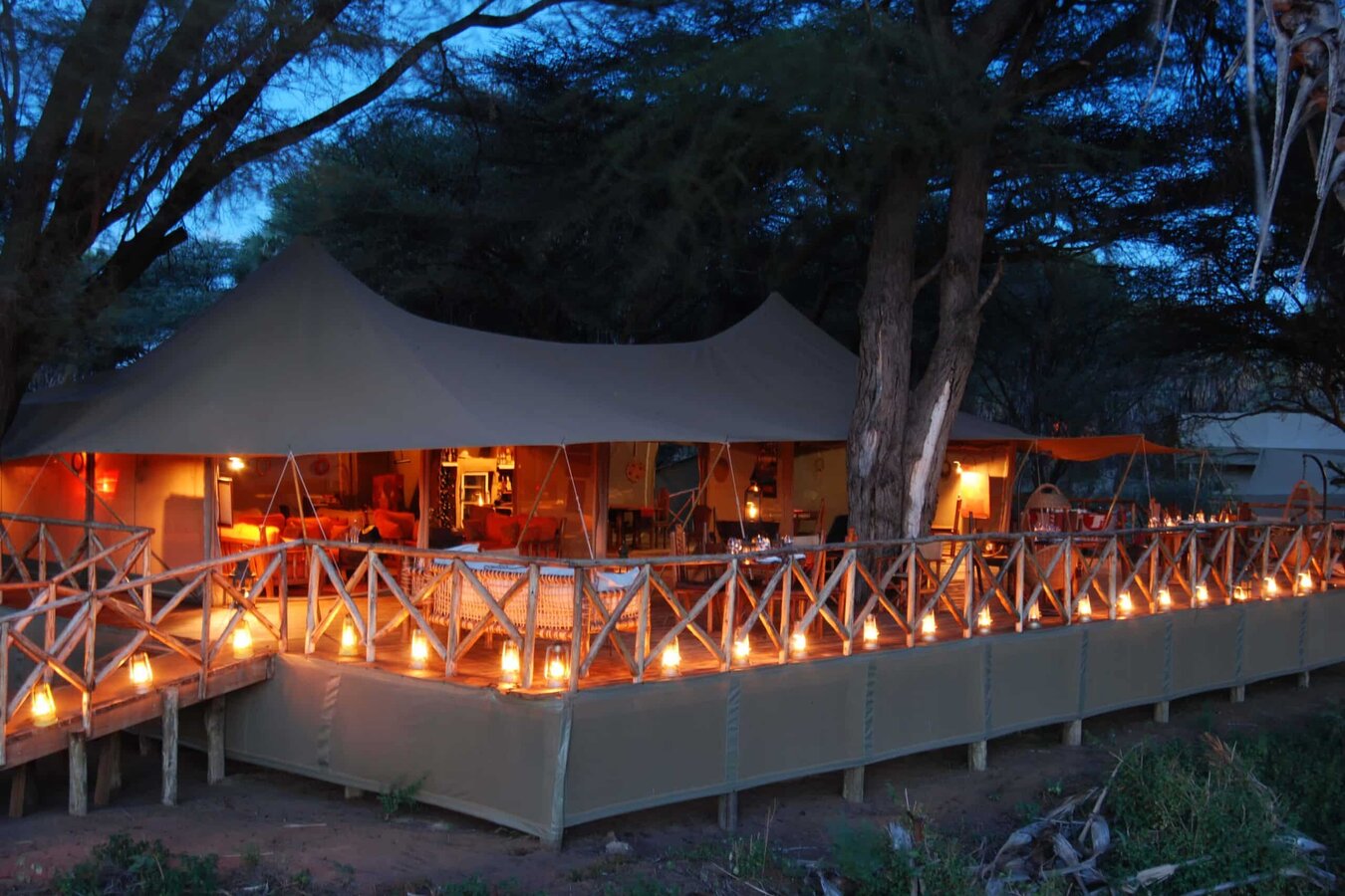 Lantern-lit dining tent glowing at night