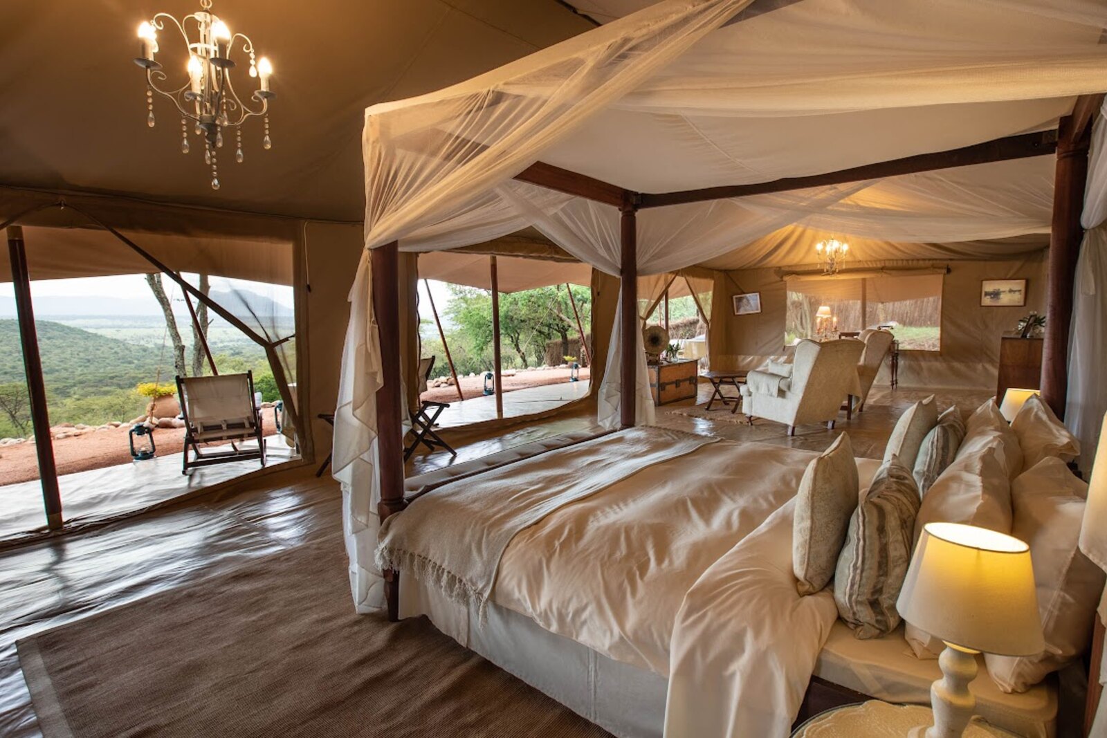 Cottar's 1920s Safari Camp four-poster bed with mosquito nets and Mara views