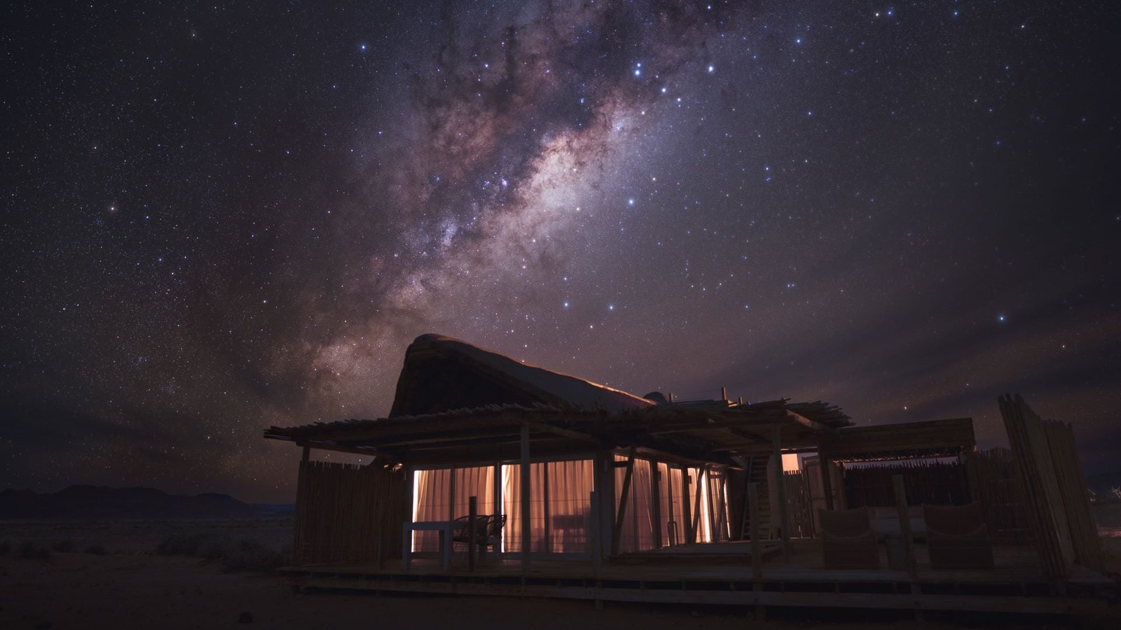 Wolwedans Dunes Lodge deck overlooking the NamibRand private reserve at sunrise