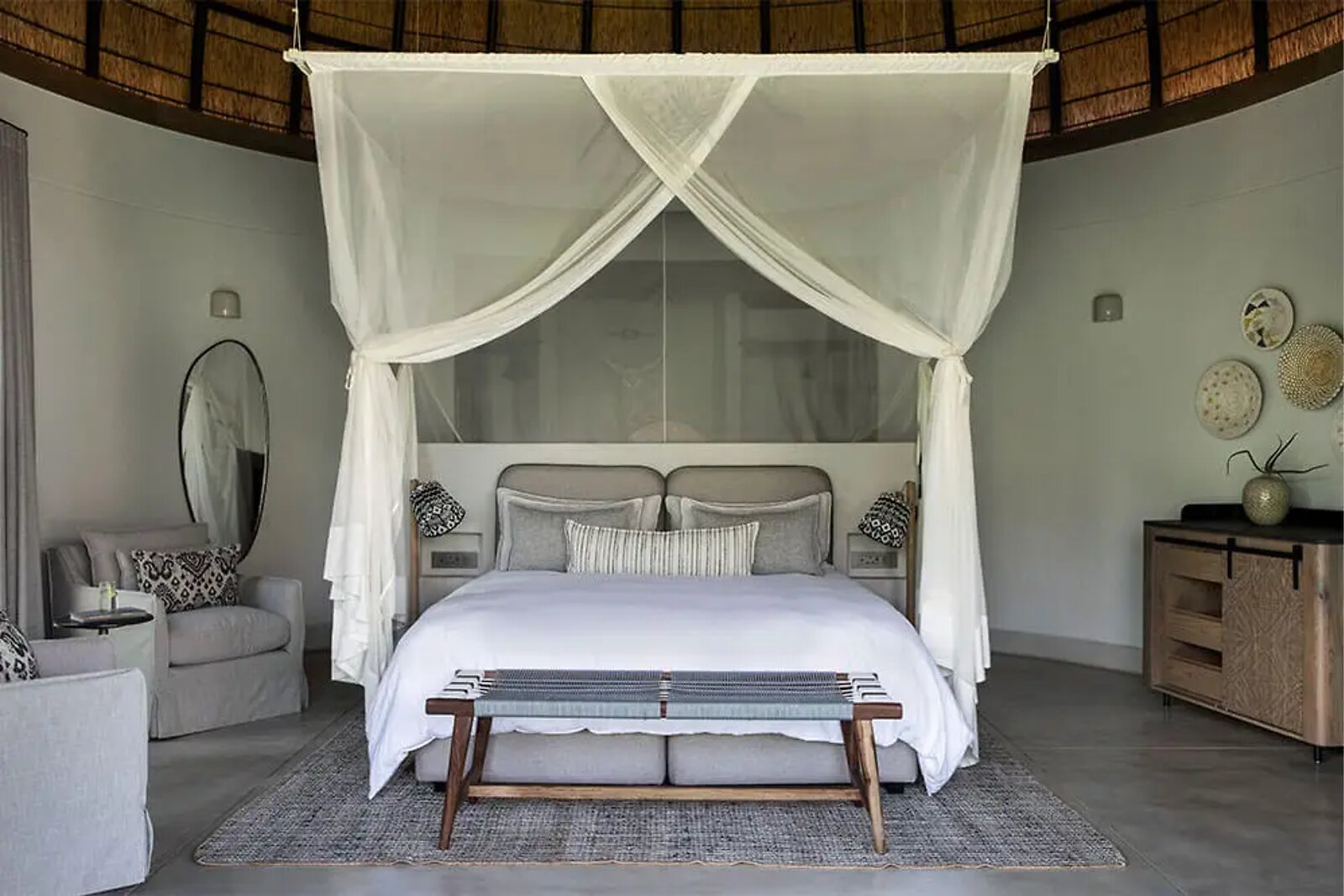 King-bedded Indlu suite with dome ceiling and natural textures at Fifty-Five Mjejane