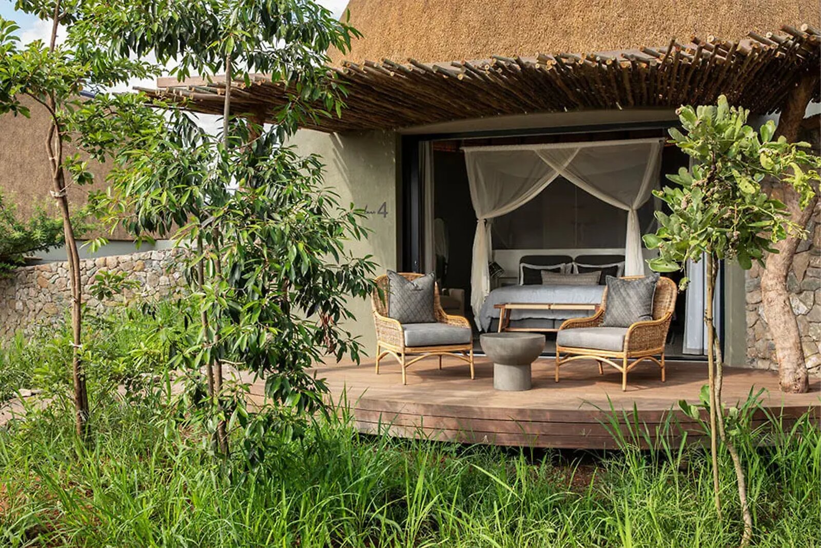 Private furnished outdoor deck of an Indlu suite overlooking the bush at Fifty-Five Mjejane