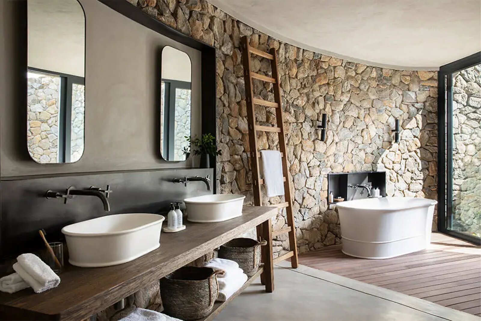 Twin vanity and bathroom detail in an Indlu suite at Fifty-Five Mjejane