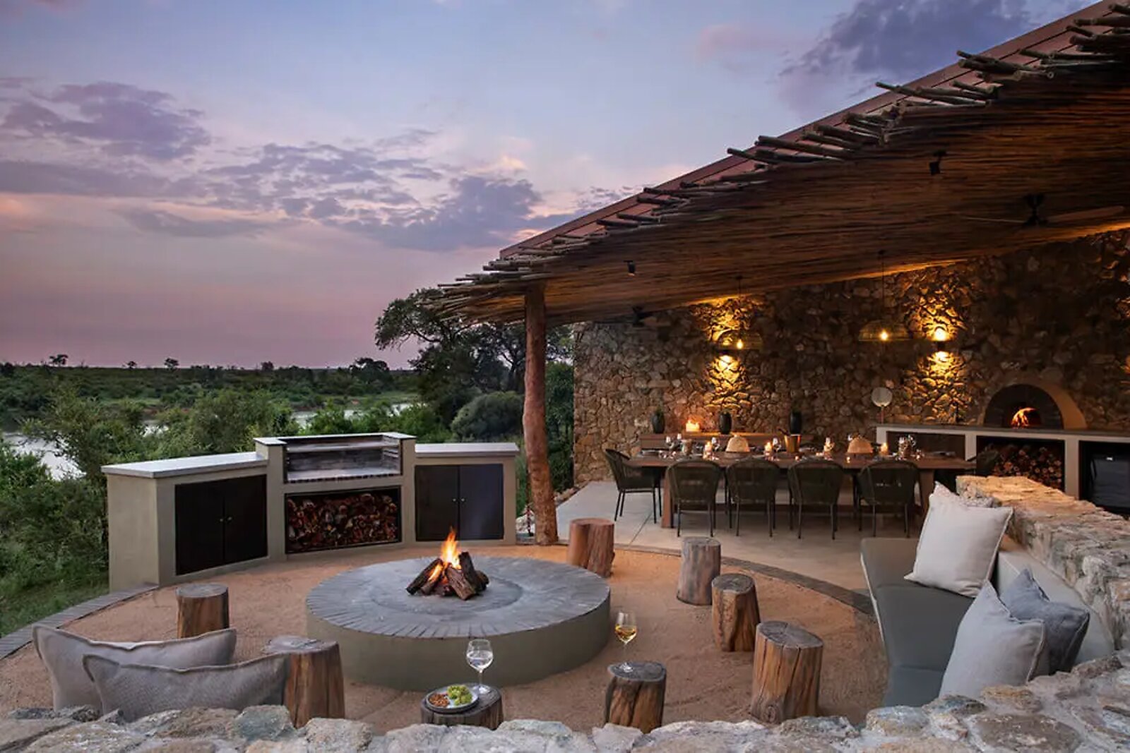 Boma fire pit glowing at dusk at Fifty-Five Mjejane