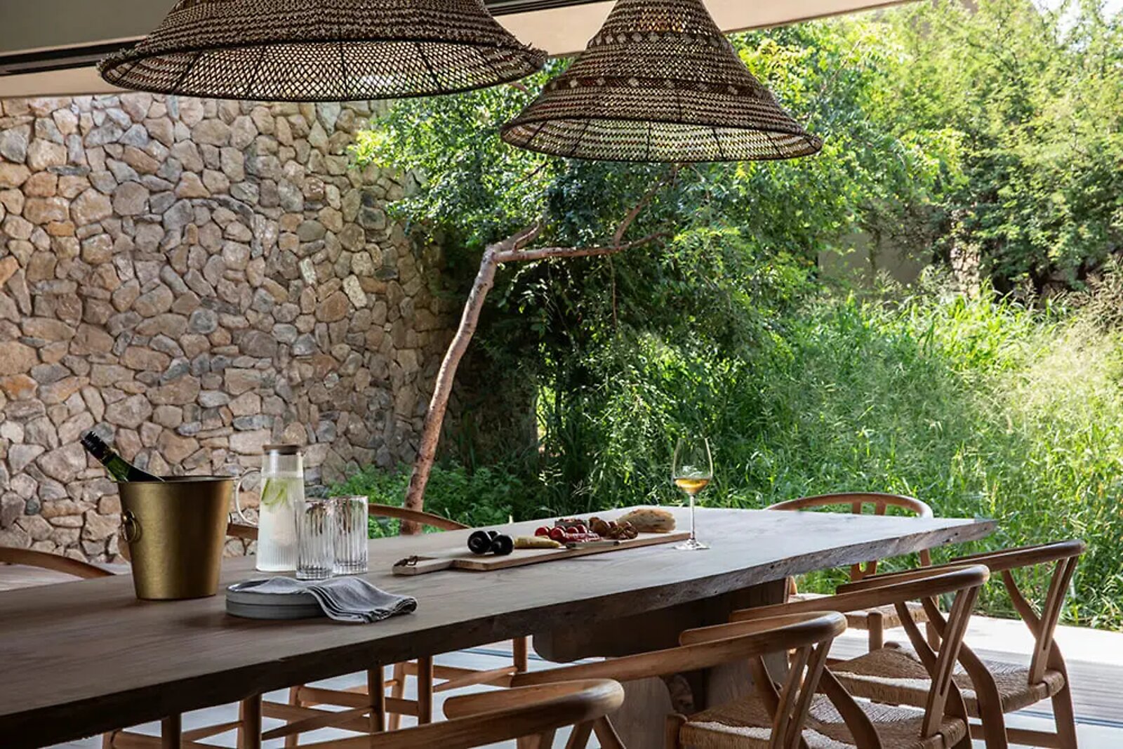 Stone bar and lounge with bush views at Fifty-Five Mjejane