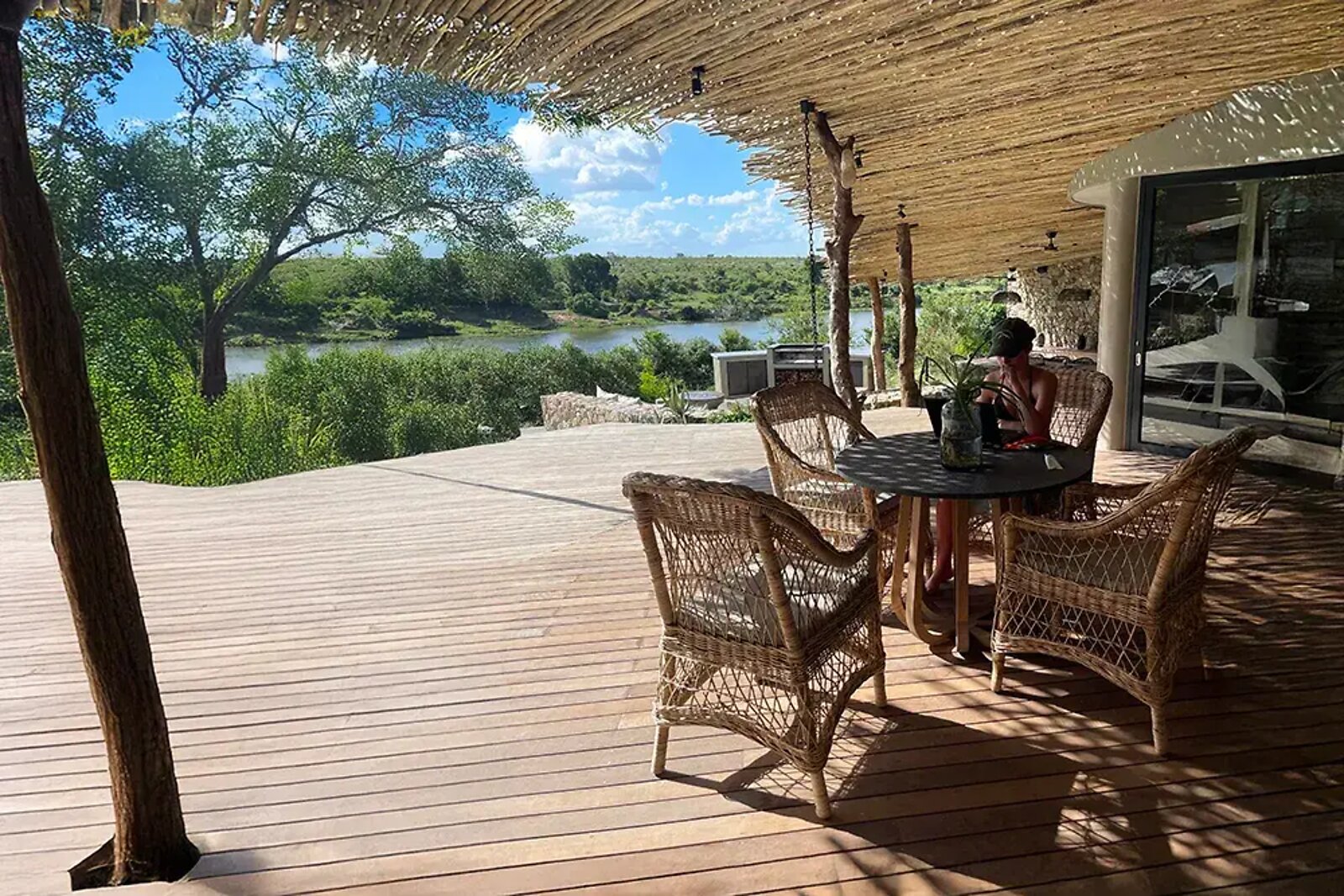 Outdoor deck dining area overlooking the Crocodile River at Fifty-Five Mjejane