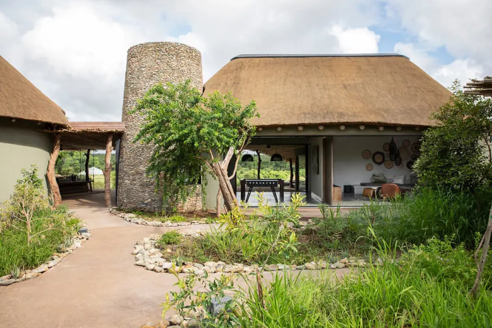 The stone-and-thatch entrance tower and dome architecture of Fifty-Five Mjejane in Greater Kruger
