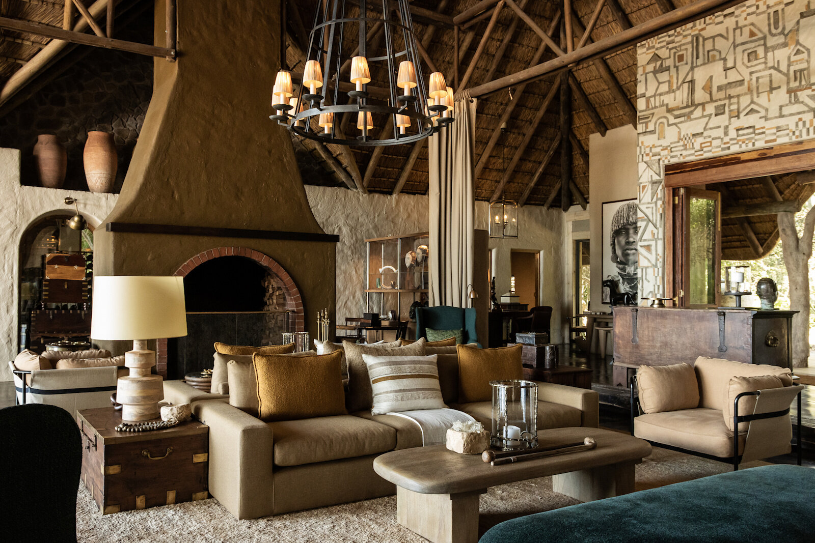 A fireside lounge at a luxury safari lodge in the evening
