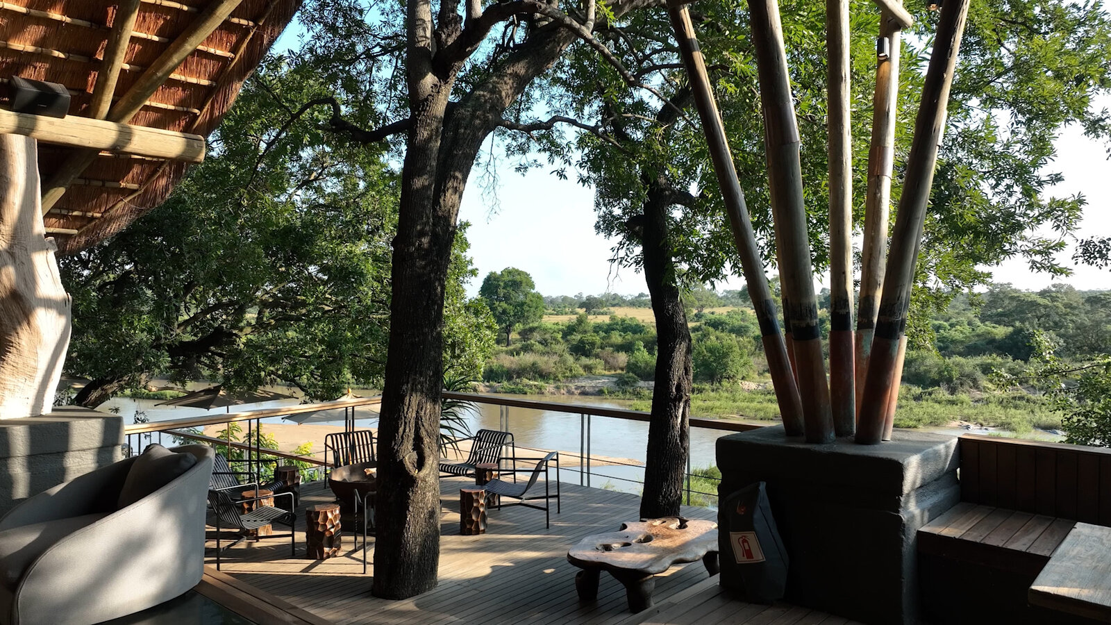 A shaded lodge deck set for lunch overlooking the bush
