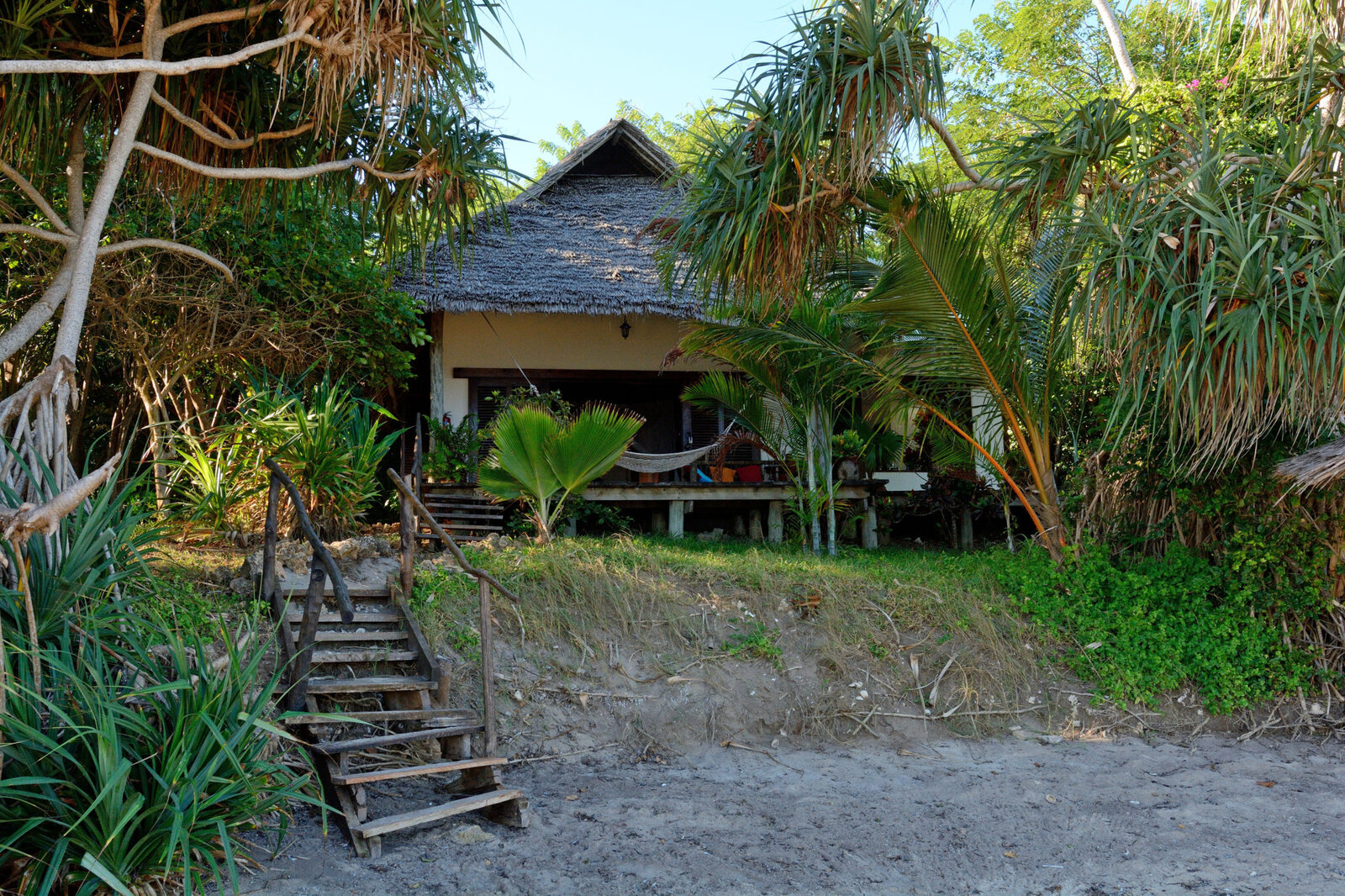 Sea-view cottage with thatched roof and steps to the beach at Fumba Beach Lodge, Zanzibar