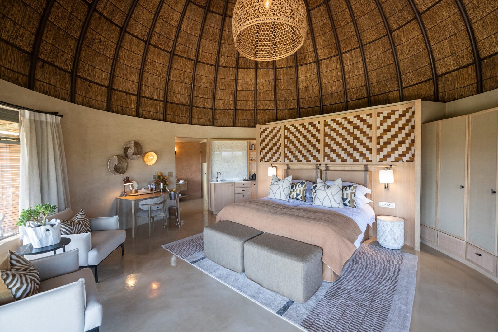 Kwena Lodge main building with infinity pool and fynbos mountain backdrop at Gondwana Game Reserve