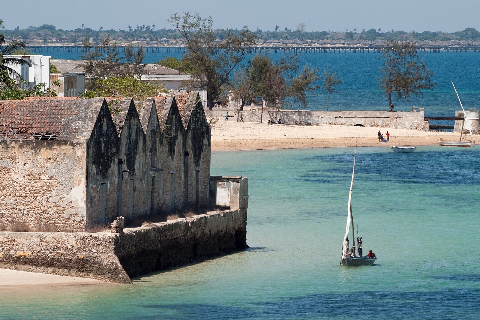 A dhow beside a stone jetty in the turquoise sea at Ilha de Moçambique