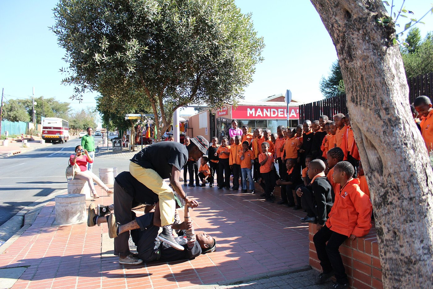 Street performers and schoolchildren on Vilakazi Street, Soweto