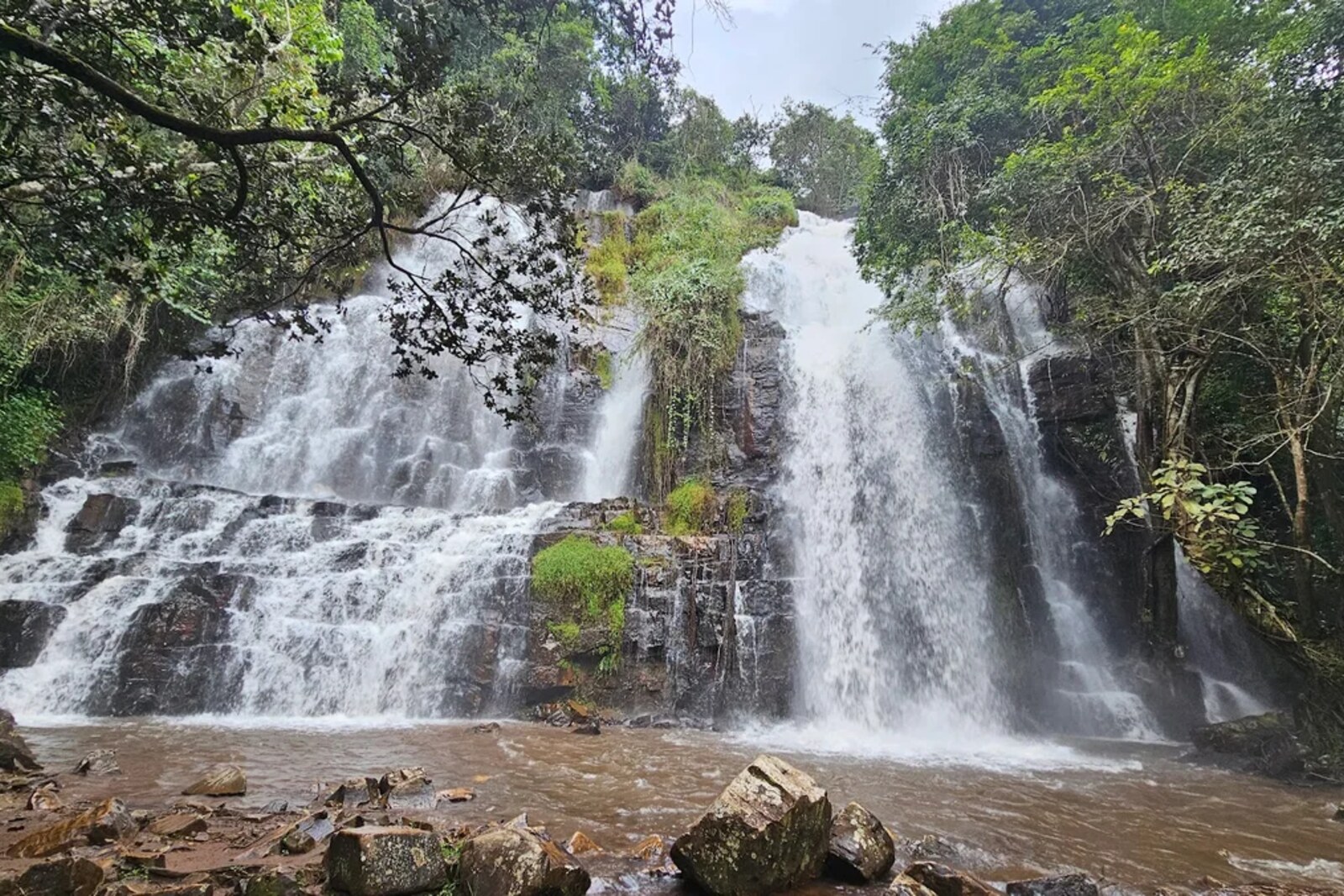 Multiple tiers of Karera Falls over dark rock