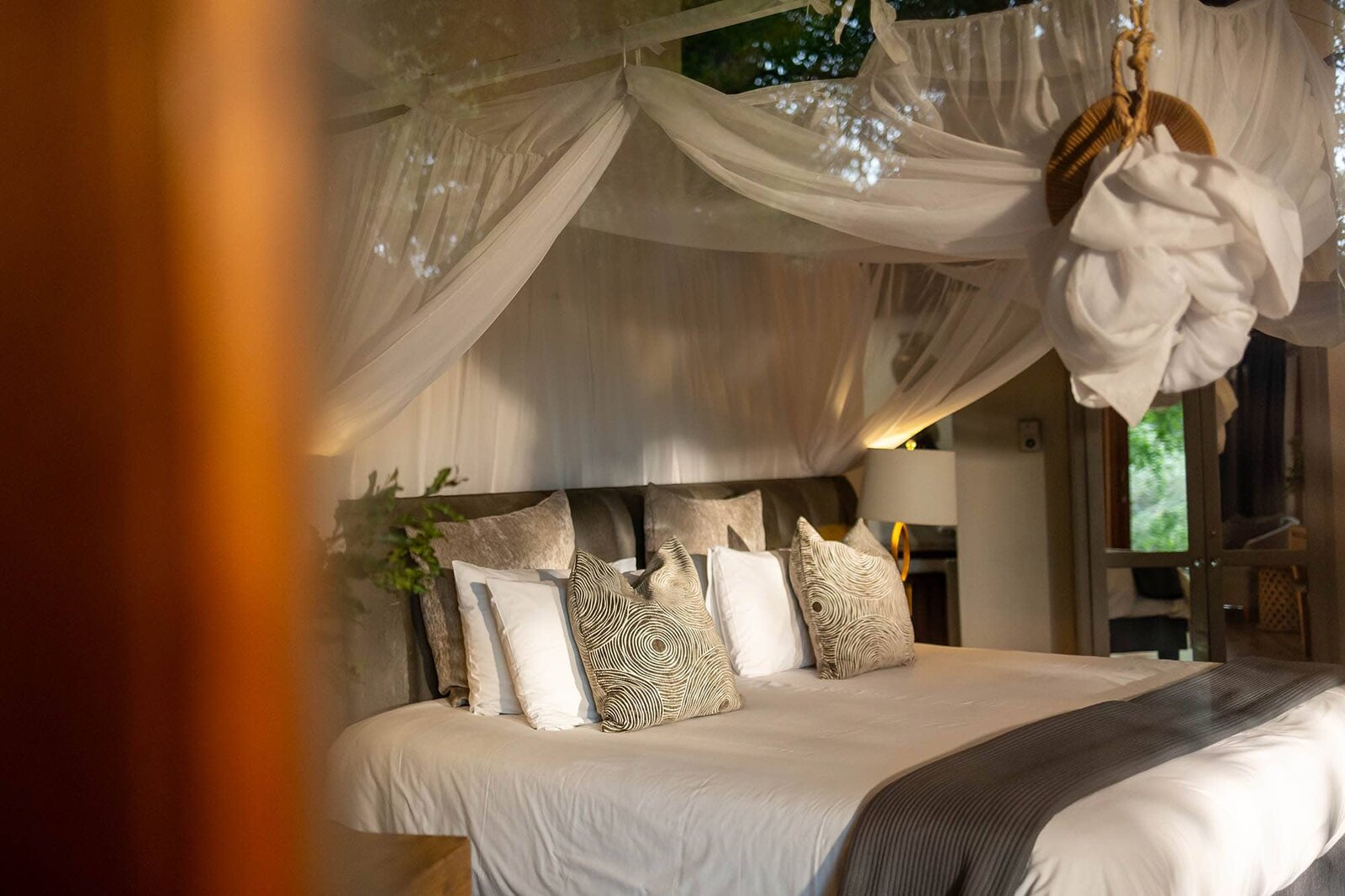 Minimalist five-star safari suite with a glass wall and waterhole view at Karongwe Private Game Reserve
