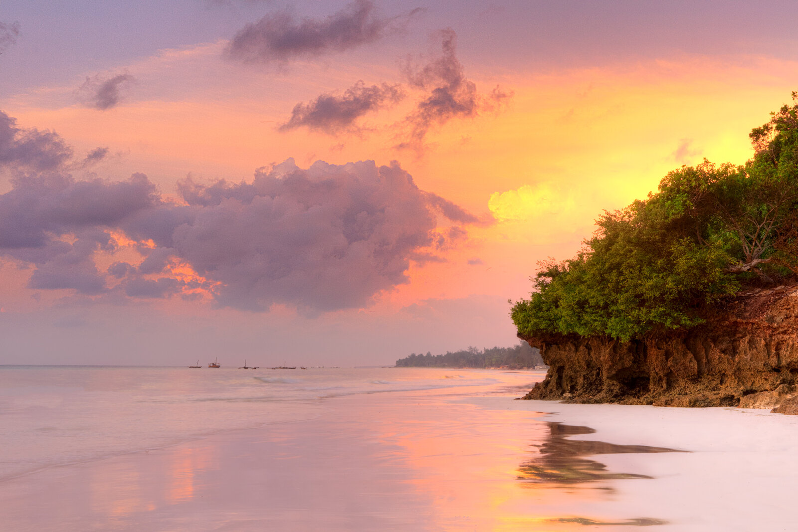 A pink and gold sunset over the Kenyan coast at Diani Beach
