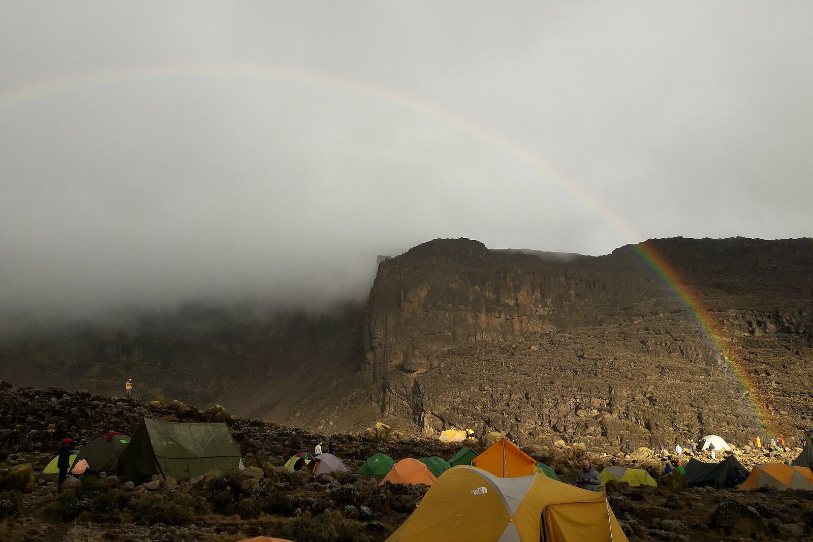 A rainbow over tents at Barranco Camp beneath the Barranco Wall on Kilimanjaro