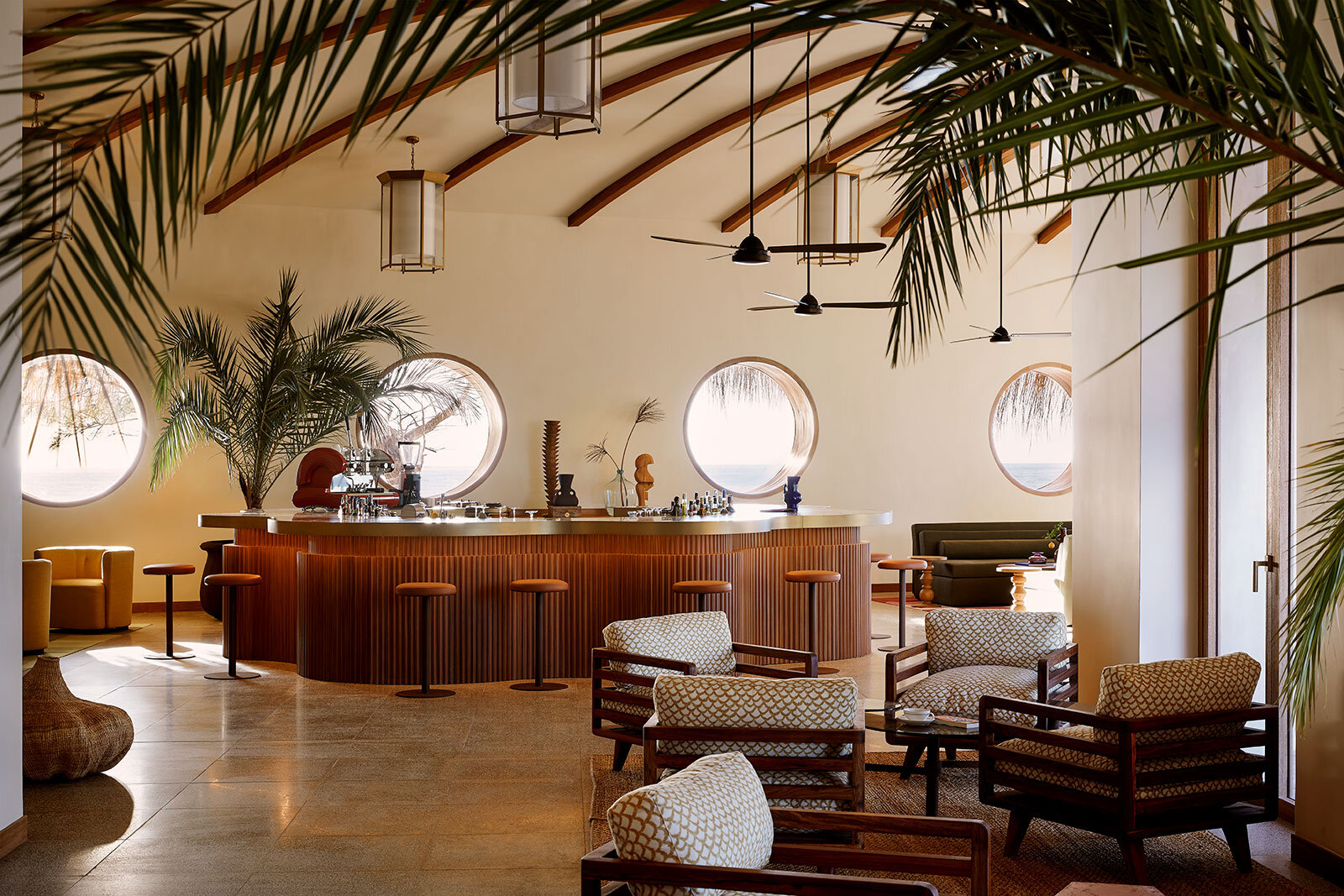 The interior of a Kisawa Sanctuary residence with soaring thatch, natural linens and hand-woven textiles