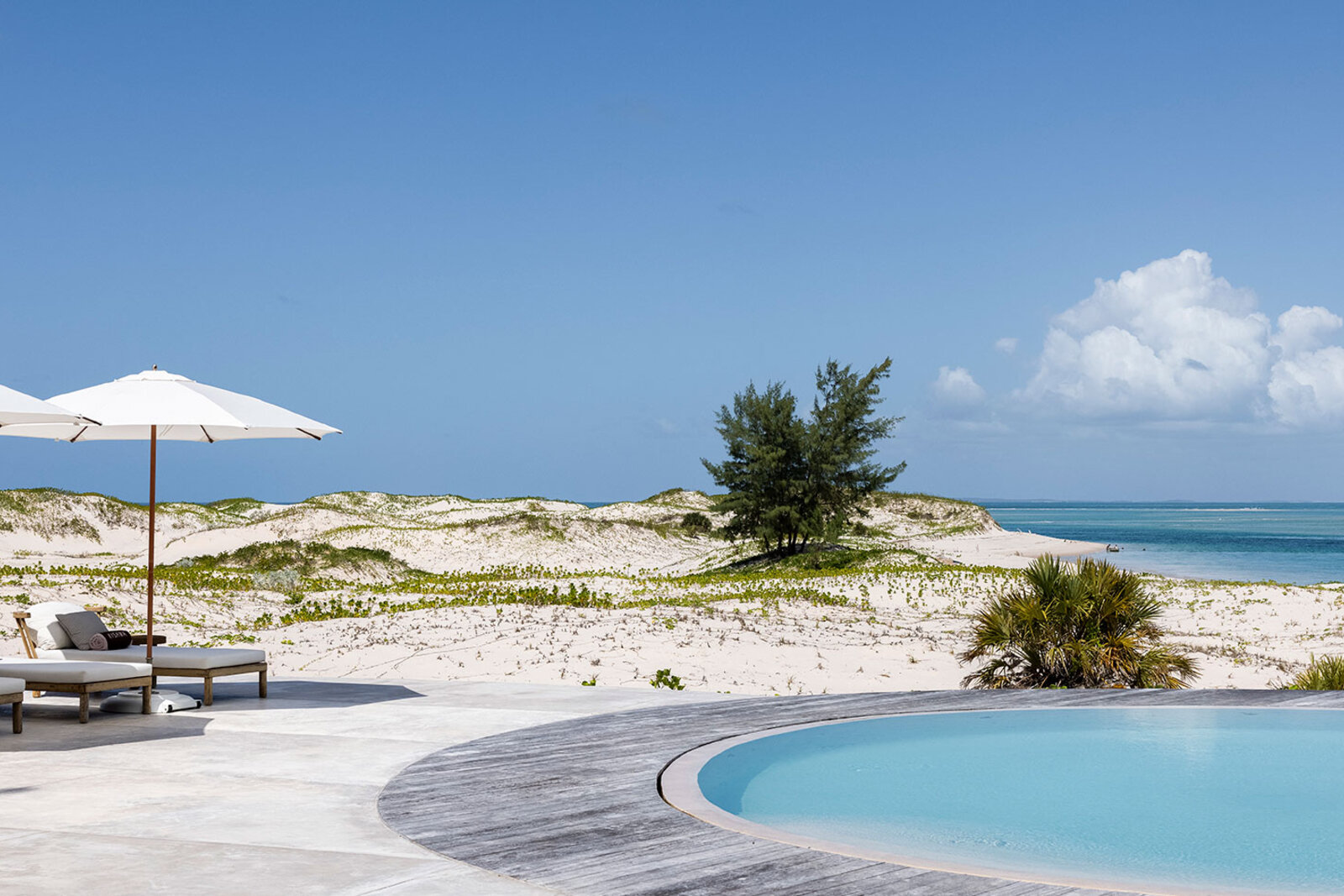 A private pool and loungers at a Kisawa Sanctuary residence overlooking the Indian Ocean on Benguerra Island