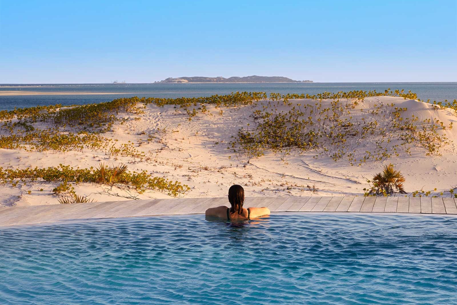 An infinity pool at Kisawa Sanctuary overlooking Benguerra Island and the turquoise Bazaruto shallows, Mozambique
