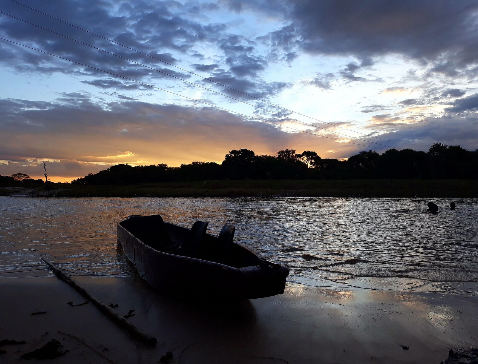 Water-level cruising by mokoro and boat &mdash; drifting past hippo and elephant