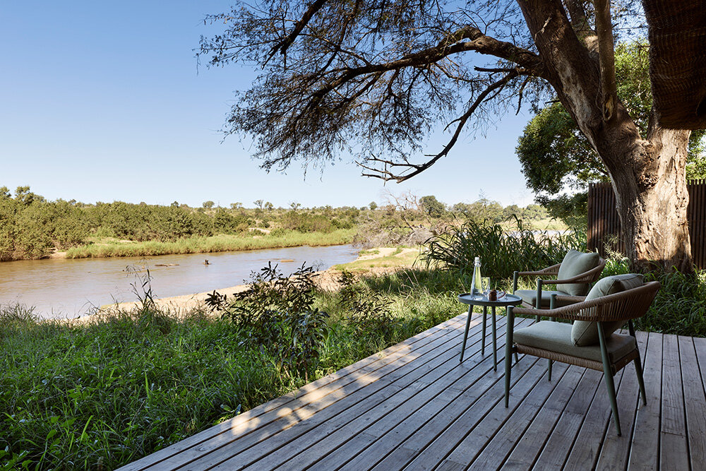 Lion Sands River Lodge deck with chairs overlooking the Sabie River