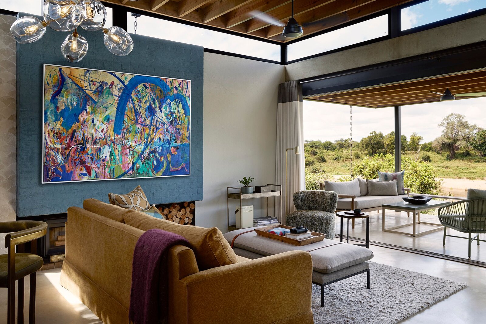 Lion Sands Ivory Lodge lounge with bold contemporary artwork and bush views