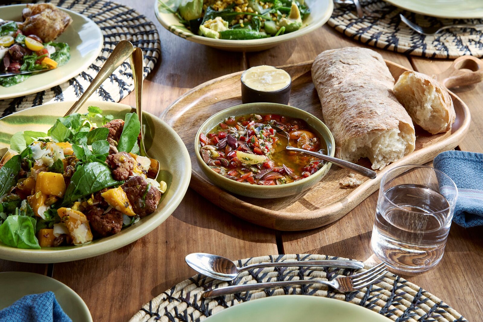Lion Sands bush lunch spread with fresh dishes laid out on a wooden table