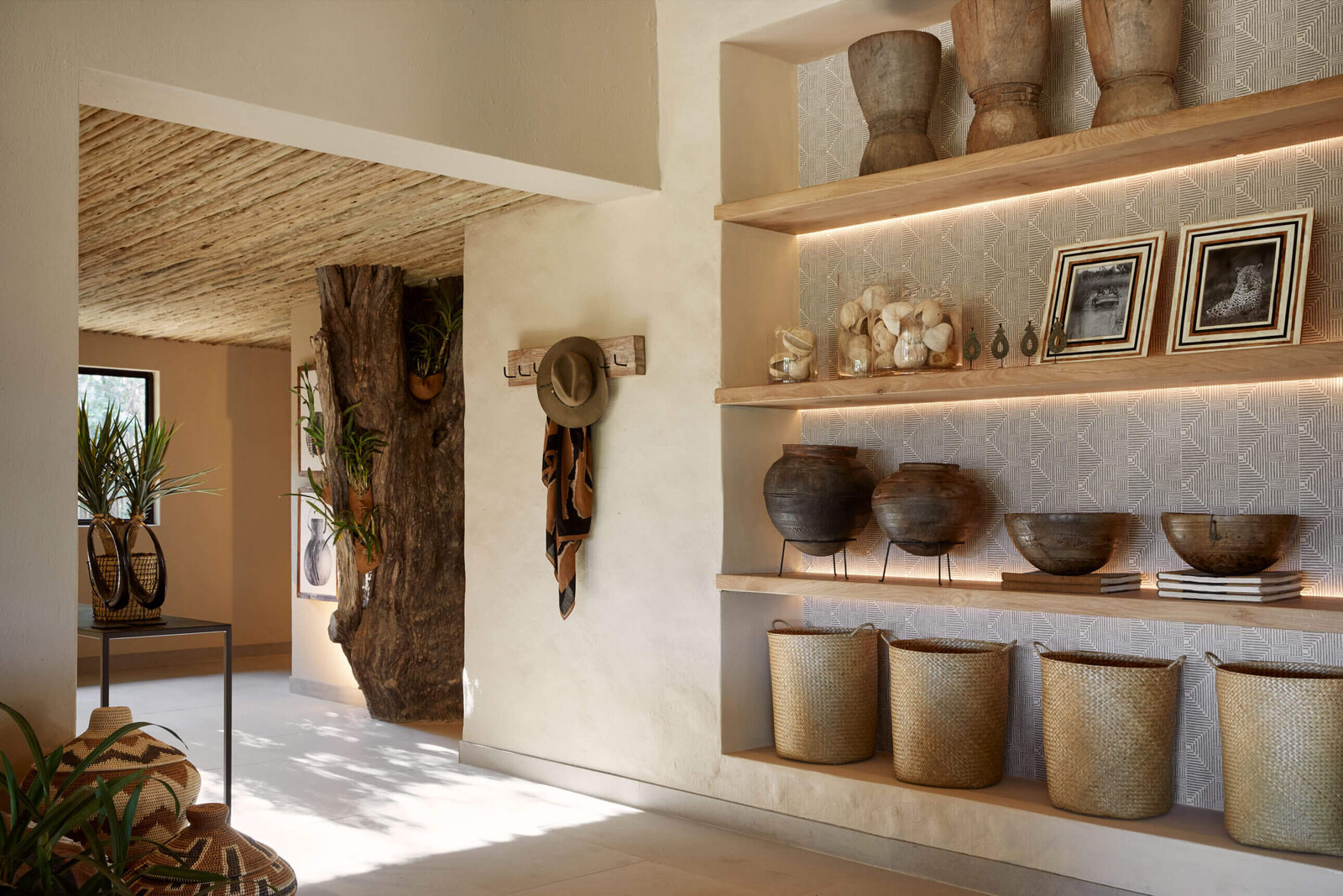 A curated interior at Londolozi Founders Camp with natural textures, artefacts and framed photography