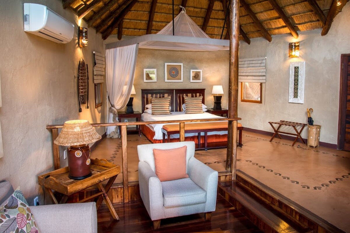 Deck chairs on a private suite deck at Lukimbi Safari Lodge in golden afternoon light