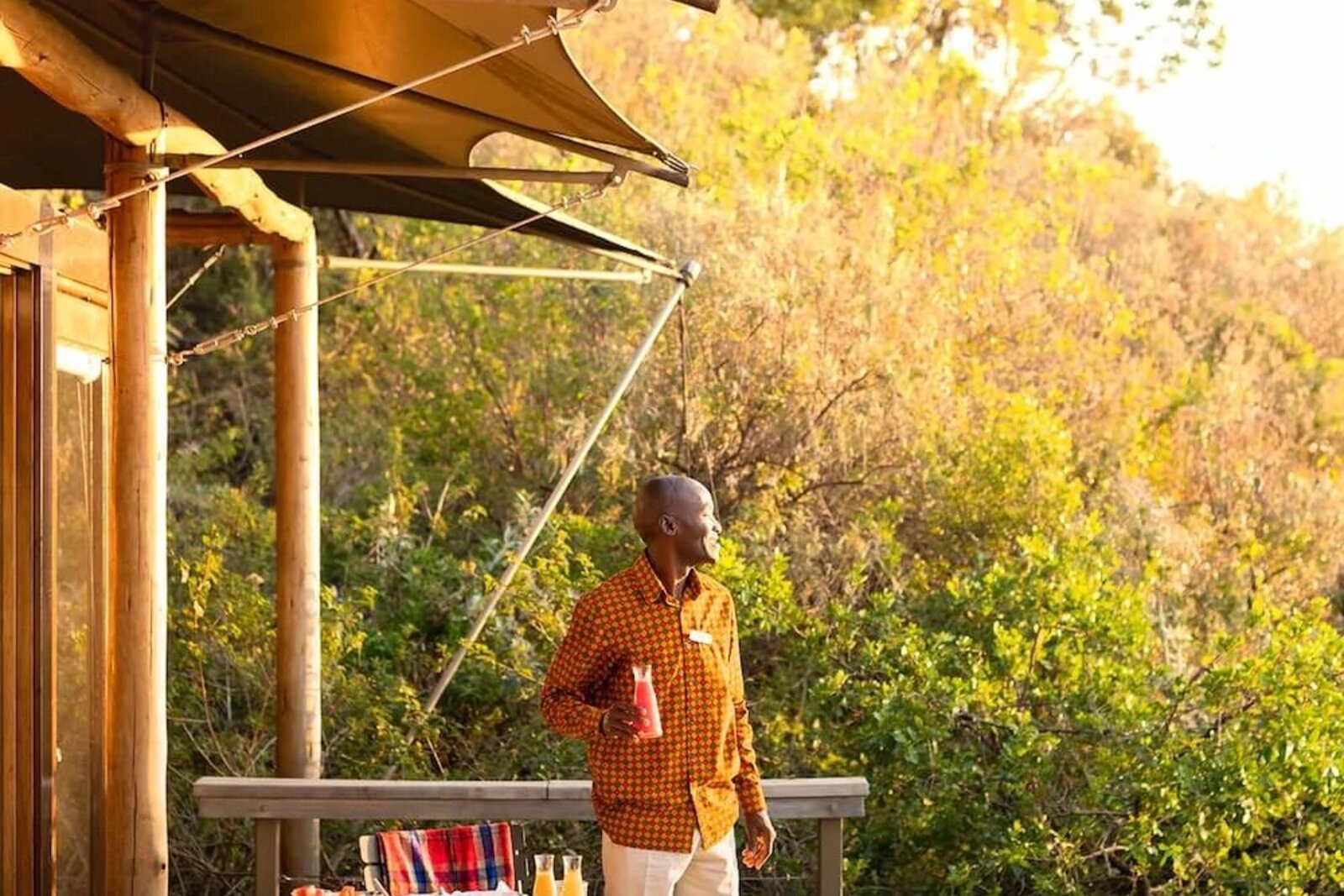 Private deck dining overlooking the Masai Mara at a luxury camp