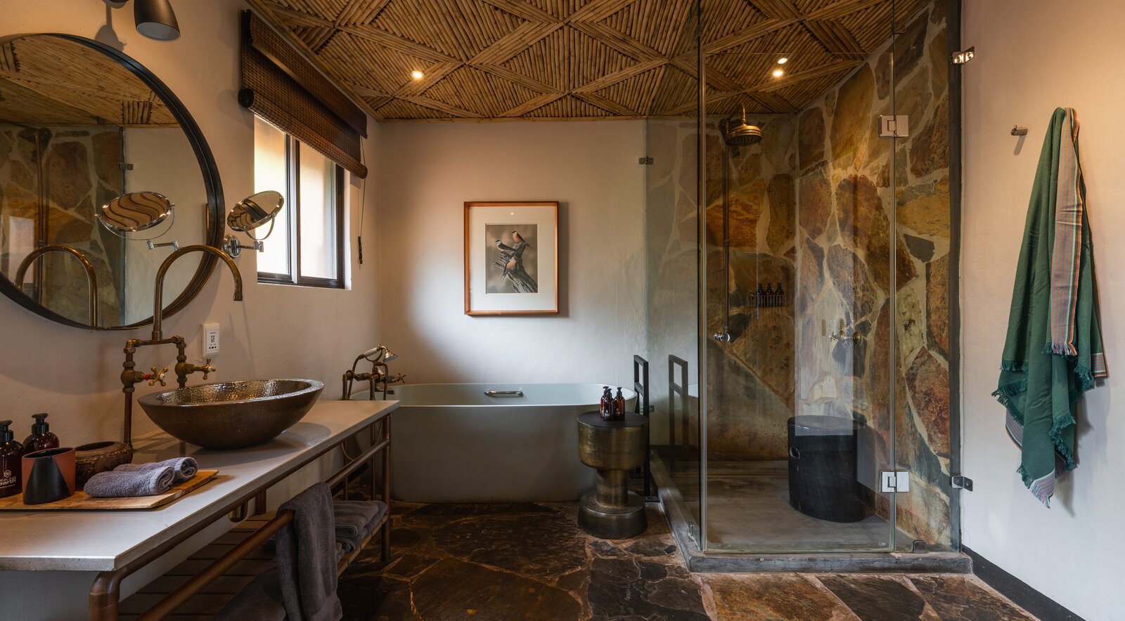 A modern en-suite bathroom at MalaMala with double vanity, walk-in shower and natural light