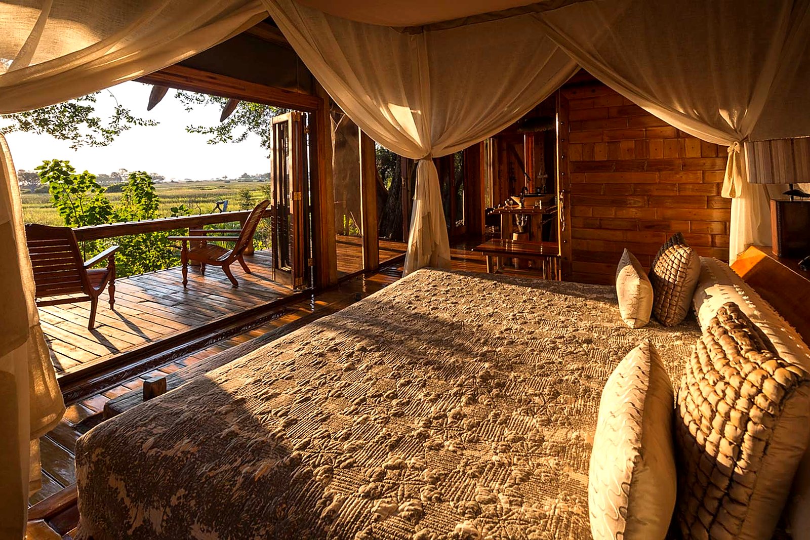 Mashatu Main Camp tented suite interior with four-poster bed and luxury furnishings