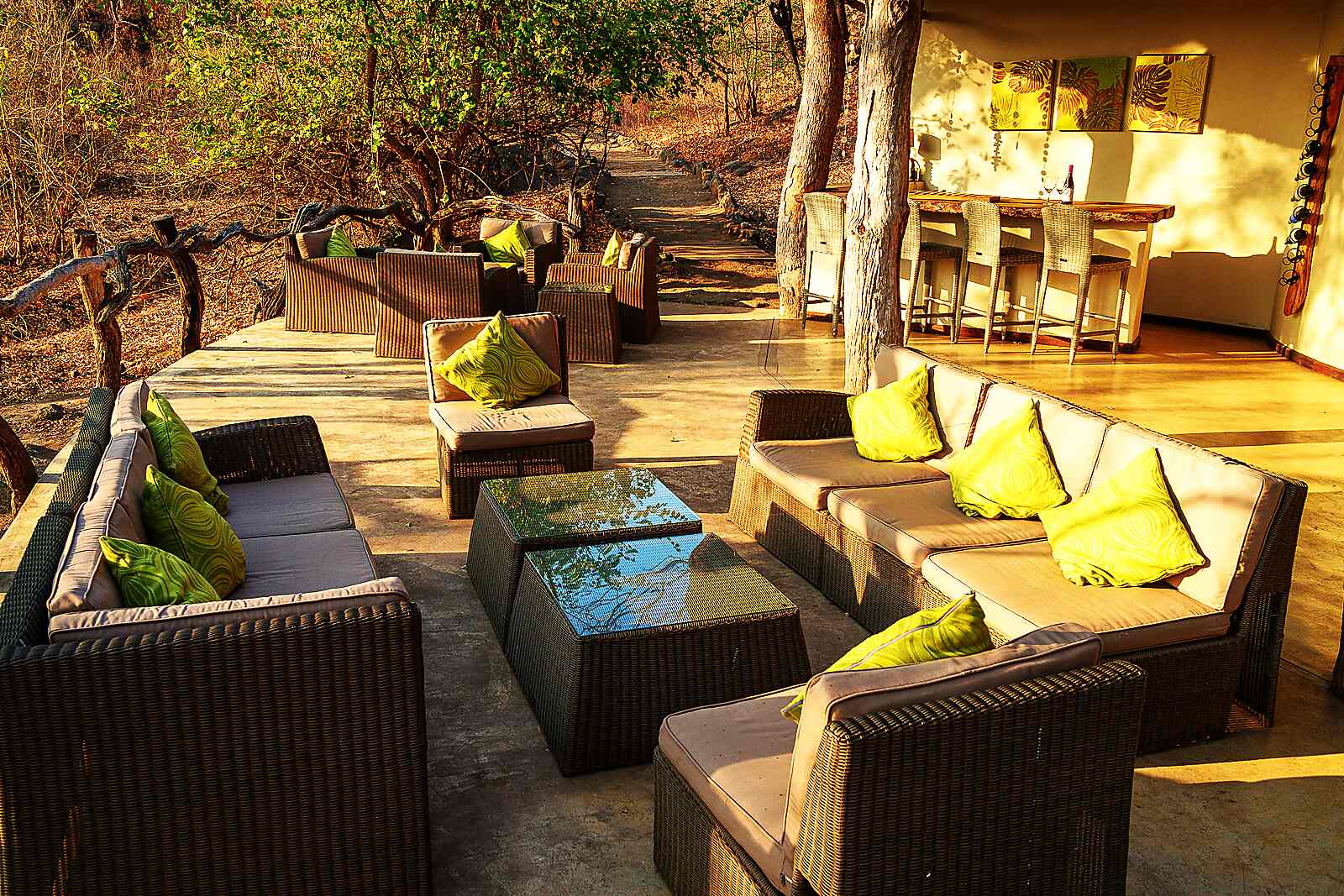 An open-sided contemporary safari lounge in stone and thatch at Mkulumadzi