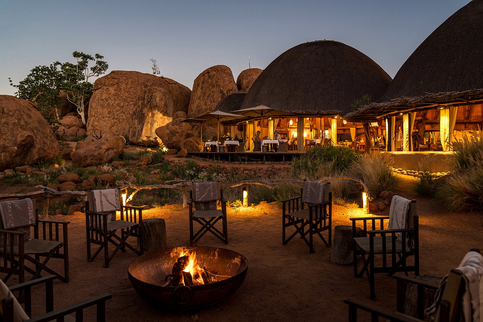 Thatched domes blending into the red boulders at Mowani Mountain Camp, Damaraland