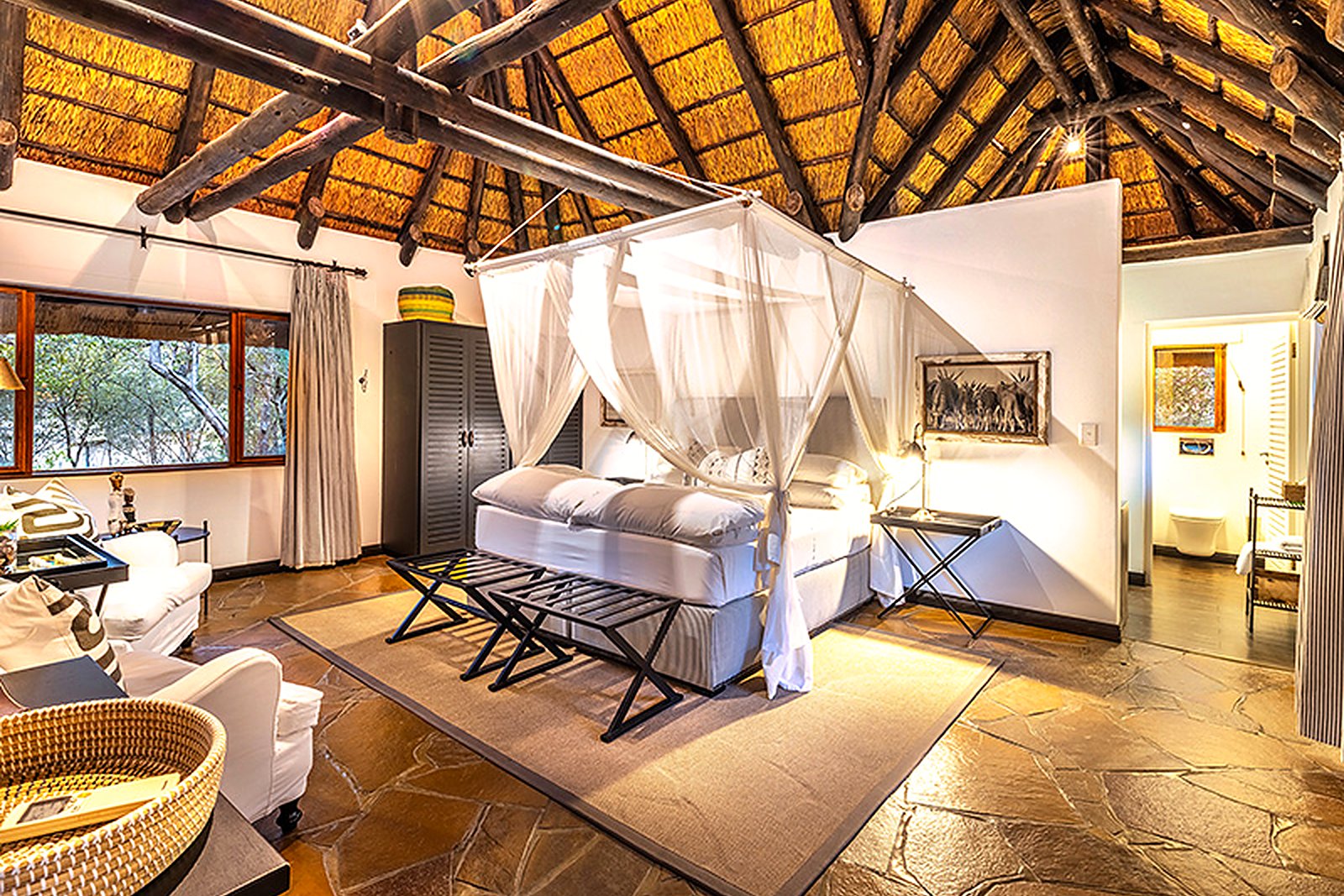 Crisp elegant chalet interior with bed and timber detail at Mushara Lodge