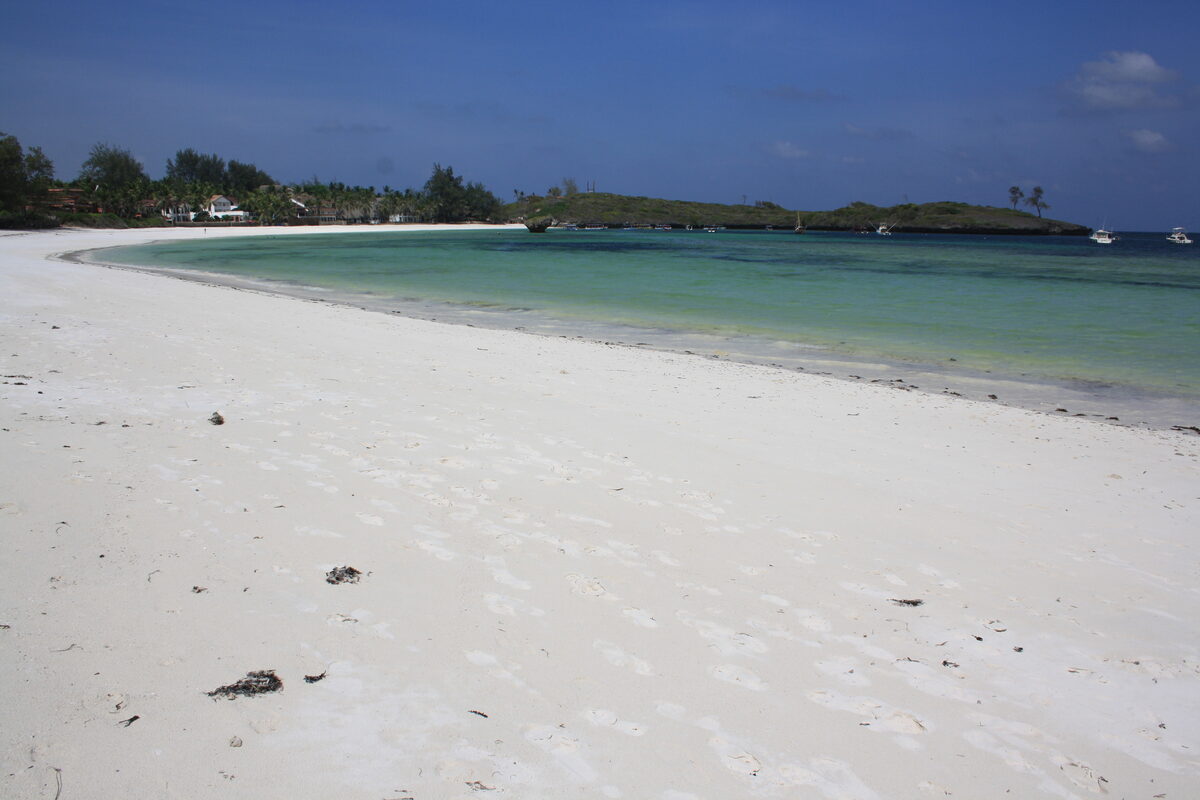 White sand beach on the Kenya coast with gentle waves near Diani