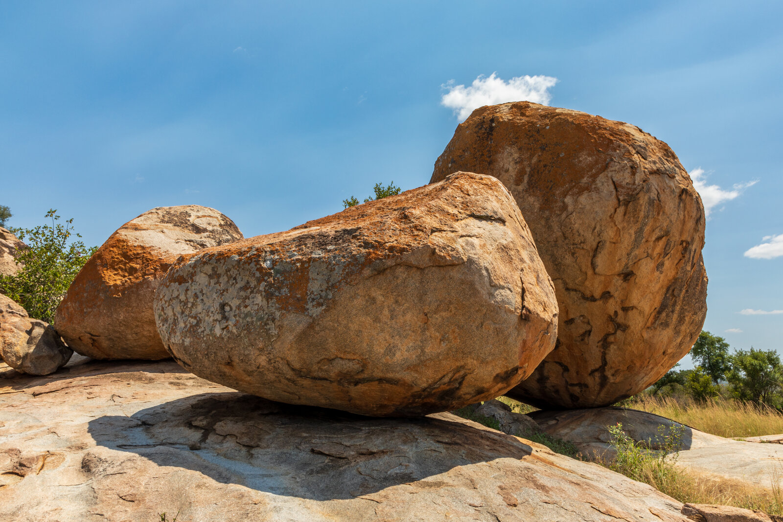 Ancient granite boulders form a koppie against a blue sky in the classic bushveld of Kruger National Park