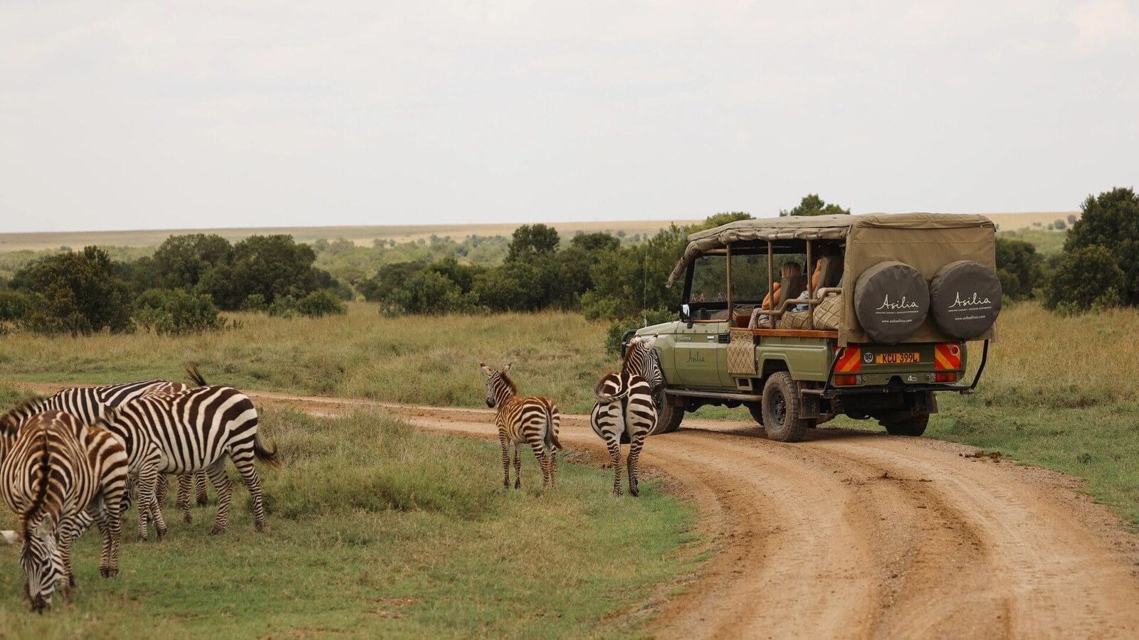 Game drive vehicle at Ol Pejeta Conservancy with Mount Kenya in background