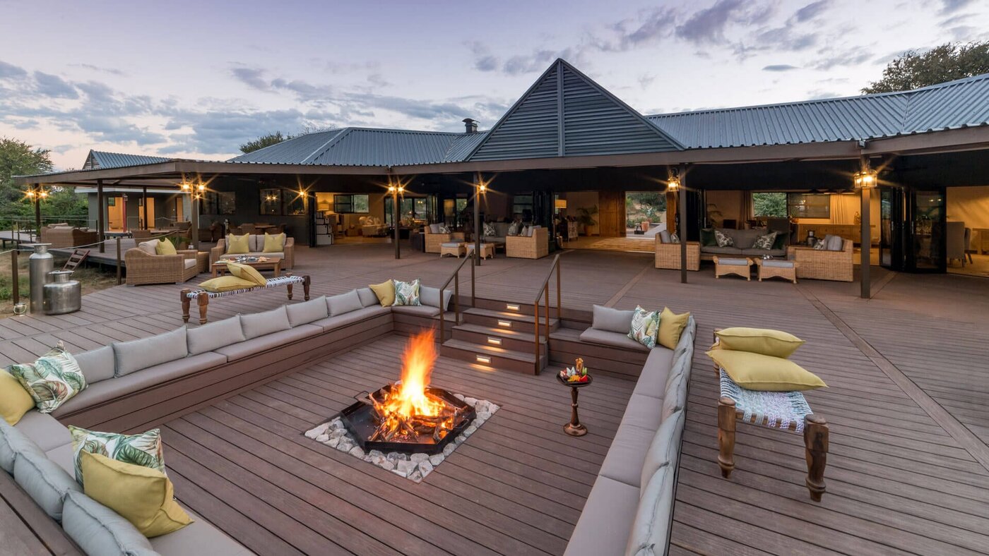 The main lodge deck and sunken firepit at Old Drift Lodge at dusk